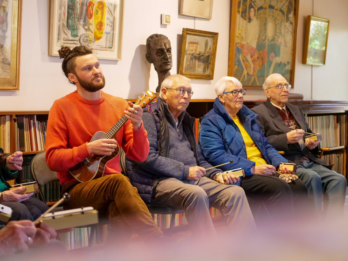 People sat down playing instruments.