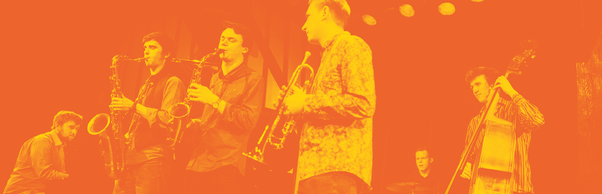 A group of musicians with instruments on a stage