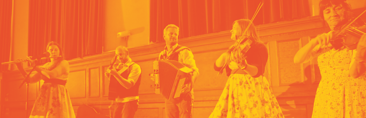 A folk band playing instruments on stage