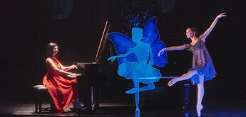 A pianist, a ballerina and a computer simulated fairy on stage.