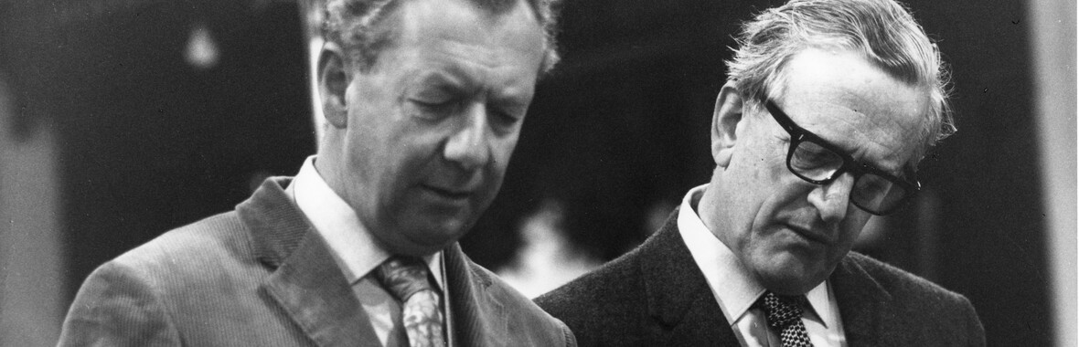 A black and white photograph of Benjamin Britten with a conductors baton.