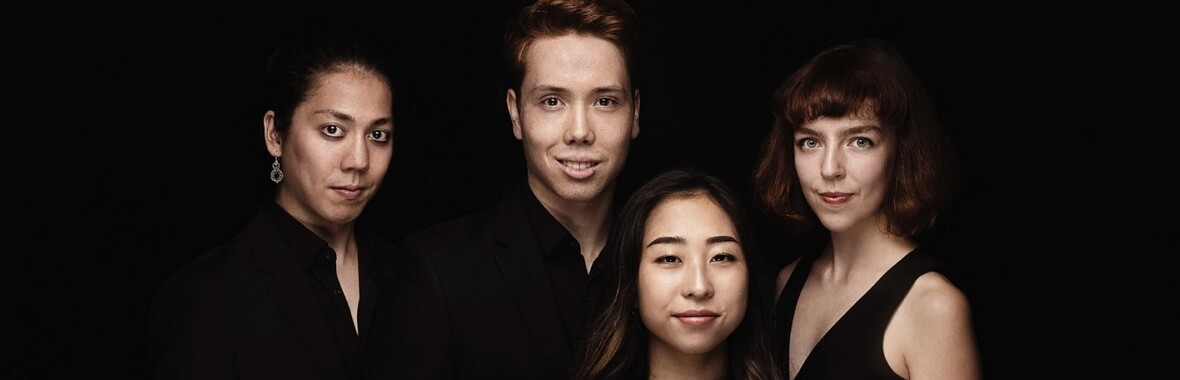 A group photo of the Leonkoro Quartet against a dark background.