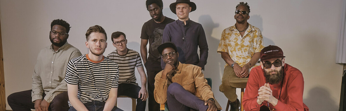 A group of musicians looking at the camera