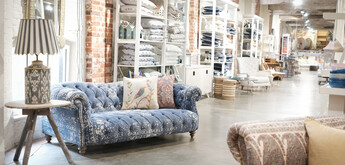 View of shop floor with sofa and lamp on table